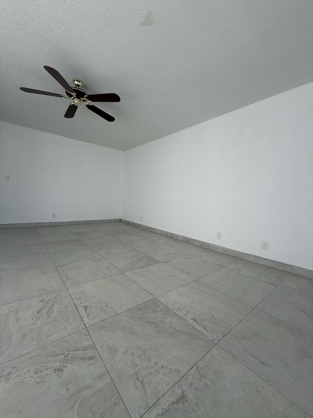 unfurnished room featuring a textured ceiling