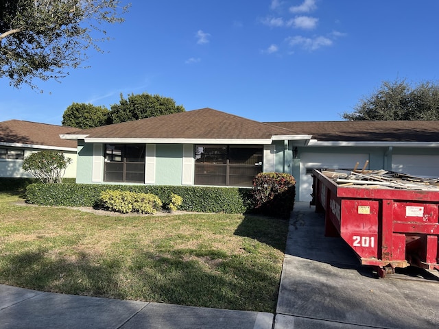 ranch-style house with a front lawn