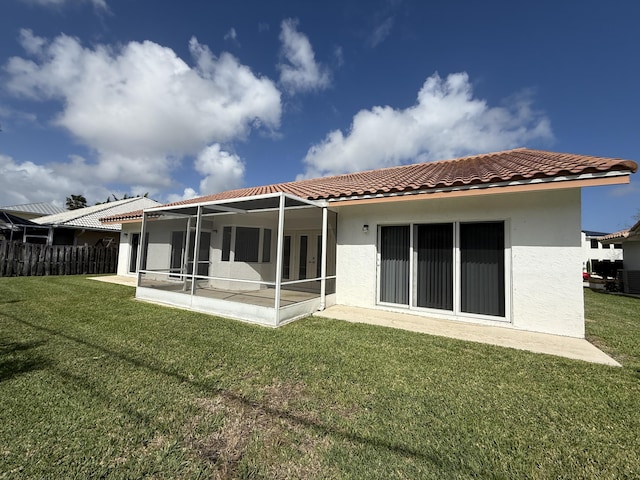 back of property with a patio area and a lawn