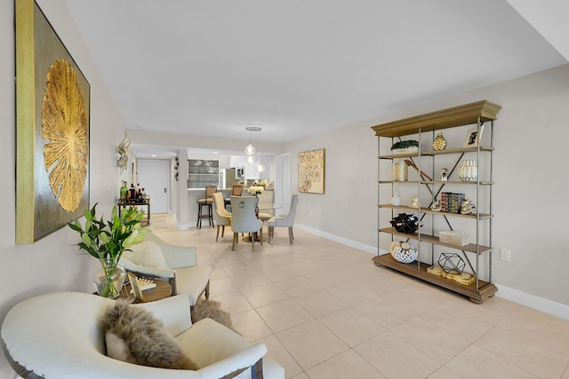 interior space with light tile patterned floors and baseboards