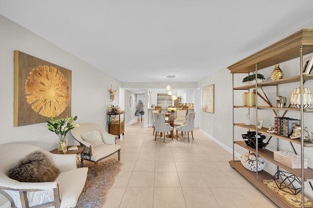 dining area with light tile patterned flooring and baseboards