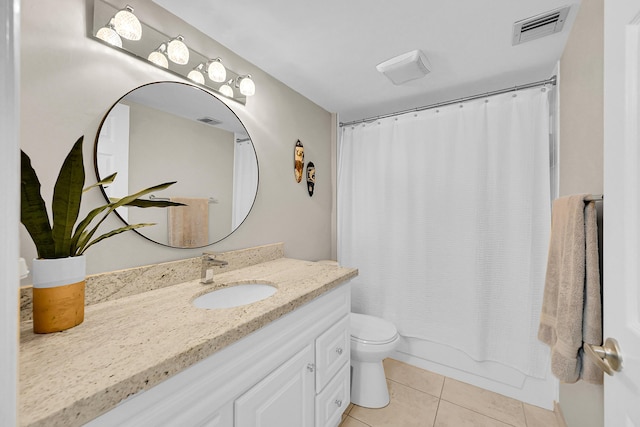 full bath featuring toilet, vanity, visible vents, and tile patterned floors