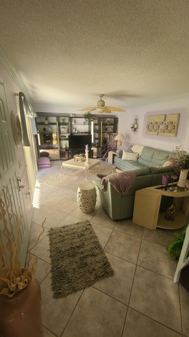 tiled living room with ceiling fan and a textured ceiling