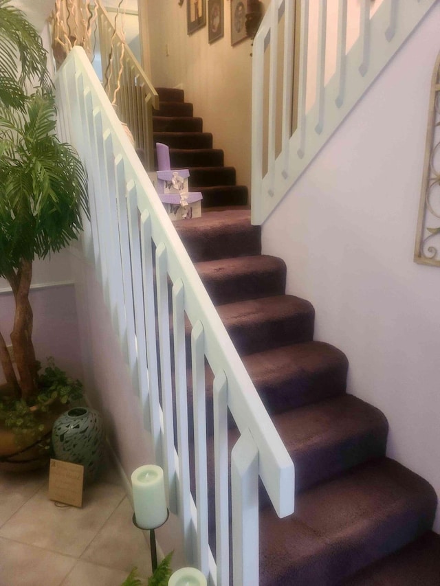 stairs with tile patterned flooring