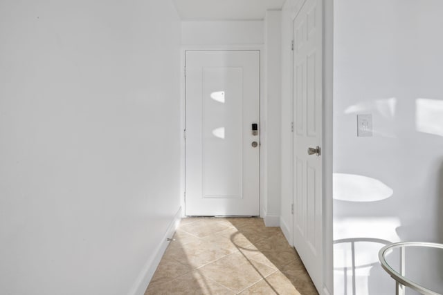 doorway with light tile patterned flooring