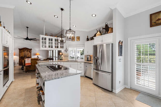 kitchen featuring white cabinetry, pendant lighting, stainless steel appliances, and a center island