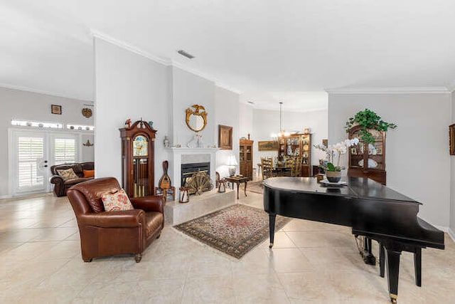 tiled living room with ornamental molding, a towering ceiling, a notable chandelier, and a high end fireplace