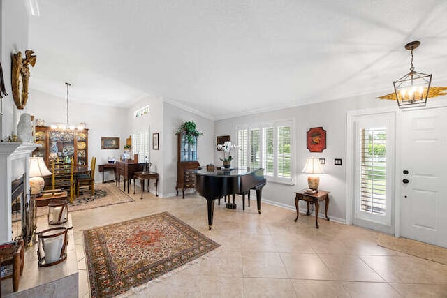 tiled entryway featuring an inviting chandelier and ornamental molding