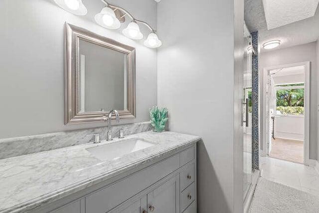 bathroom with vanity and a textured ceiling