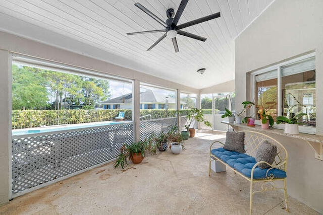 sunroom featuring lofted ceiling, wooden ceiling, and ceiling fan