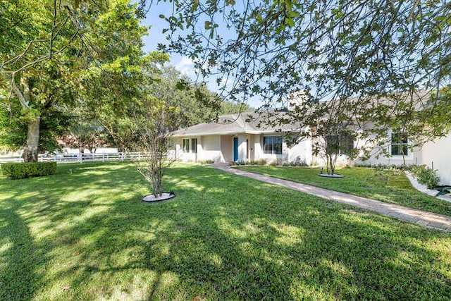 ranch-style home with a front yard