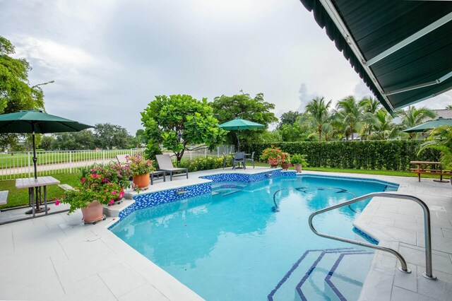 view of swimming pool with a patio area