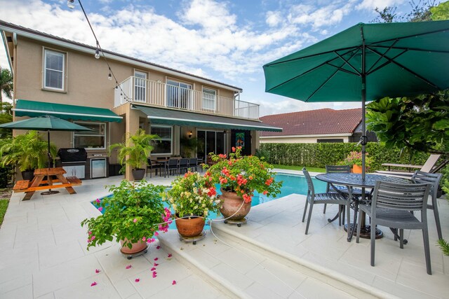 view of patio / terrace with a fenced in pool and grilling area