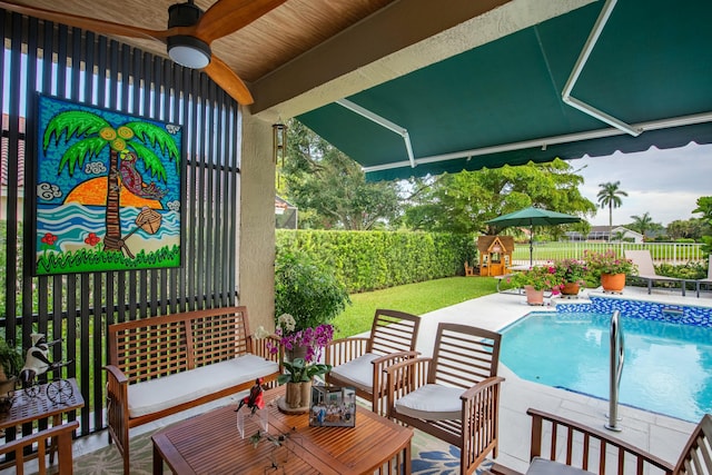 view of swimming pool with an outdoor living space, ceiling fan, and a patio area