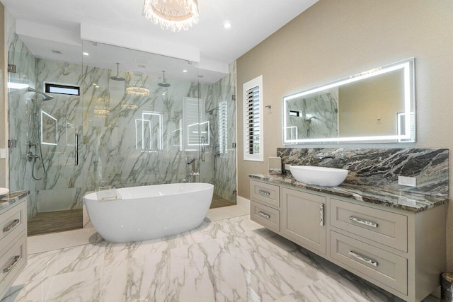 full bath featuring a freestanding bath, marble finish floor, a marble finish shower, and vanity