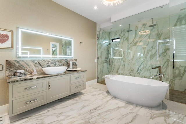 bathroom with marble finish floor, a marble finish shower, recessed lighting, vanity, and a freestanding tub