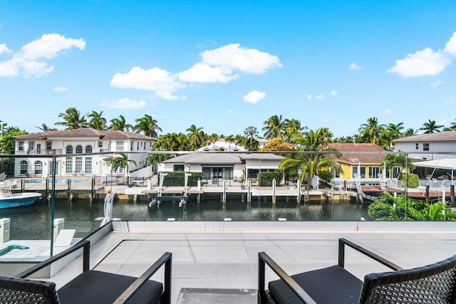 balcony featuring a dock, a water view, and a residential view