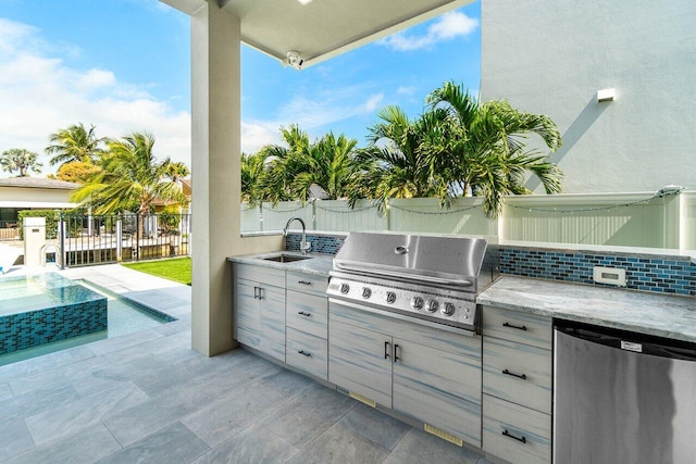 view of patio featuring a sink, area for grilling, a grill, and fence