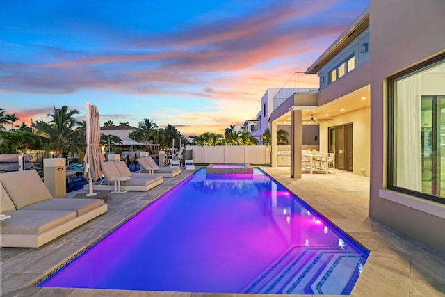 pool at dusk featuring a patio area, a fenced backyard, a fenced in pool, and outdoor dining space