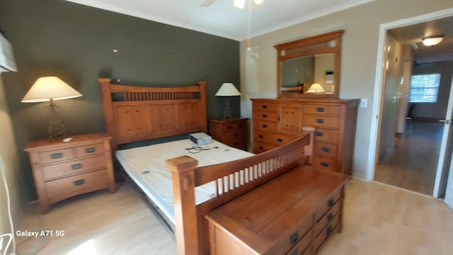 bedroom featuring crown molding and light wood-type flooring