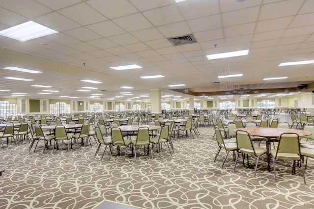 dining room featuring a healthy amount of sunlight and a paneled ceiling