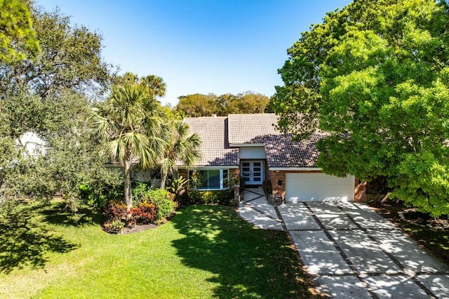 view of front of home with a garage and a front lawn