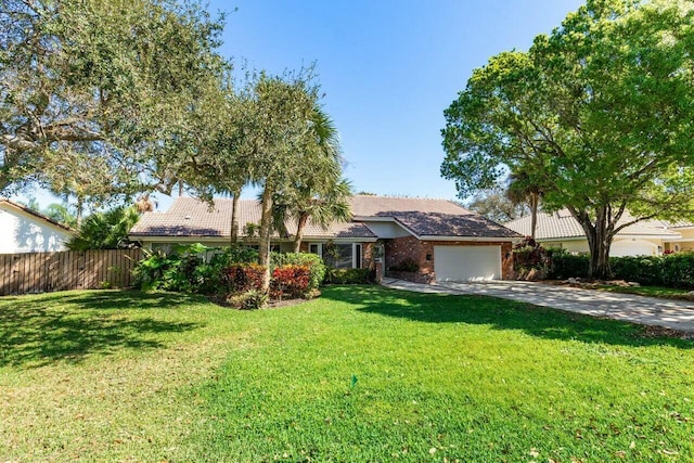 single story home featuring a garage and a front yard