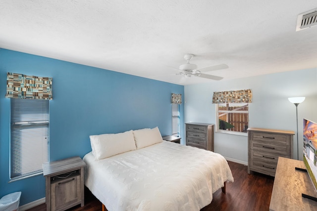 bedroom with dark wood-type flooring and ceiling fan