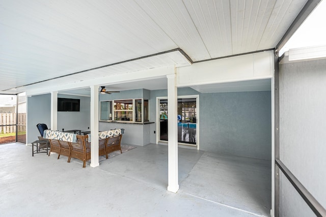 view of patio / terrace with ceiling fan and an outdoor living space