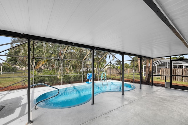 view of swimming pool featuring a lanai and a patio area