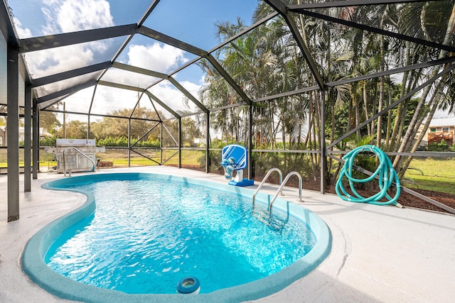 view of swimming pool featuring a lanai and a patio area