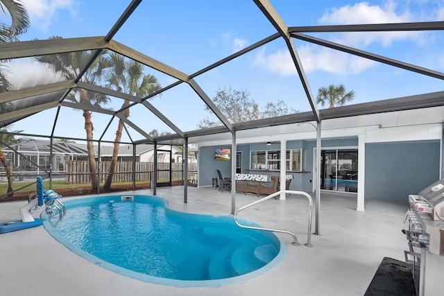 view of swimming pool featuring outdoor lounge area, a patio area, and glass enclosure