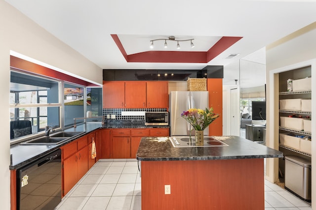 kitchen with a raised ceiling, sink, light tile patterned floors, and black appliances