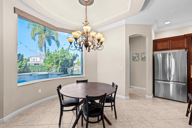 dining space featuring crown molding, a raised ceiling, an inviting chandelier, and light tile patterned floors