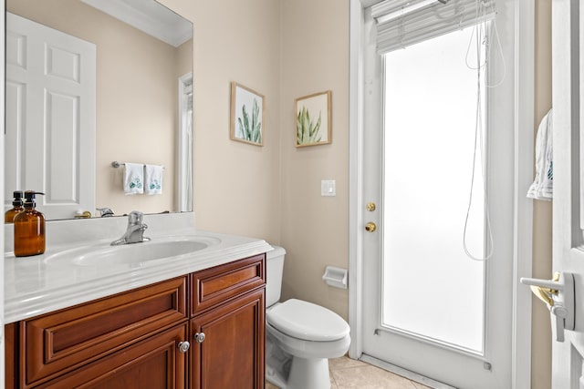 bathroom featuring tile patterned floors, toilet, vanity, and crown molding