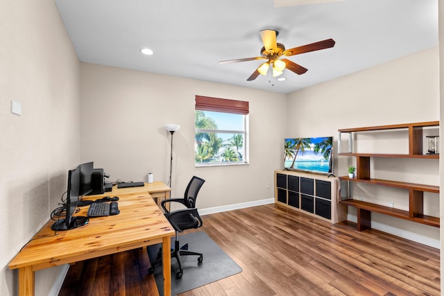 office with hardwood / wood-style flooring and ceiling fan