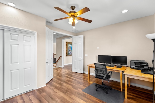 office space featuring ceiling fan and dark hardwood / wood-style flooring