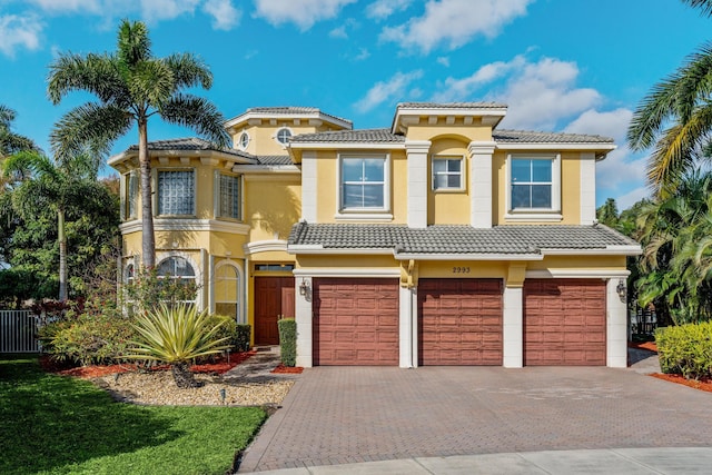 mediterranean / spanish-style home with a garage