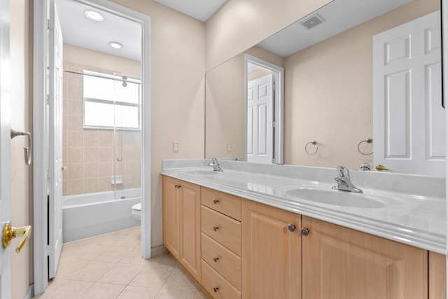 full bathroom with toilet, tile patterned flooring, vanity, and tiled shower / bath