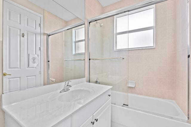 bathroom with bath / shower combo with glass door and vanity