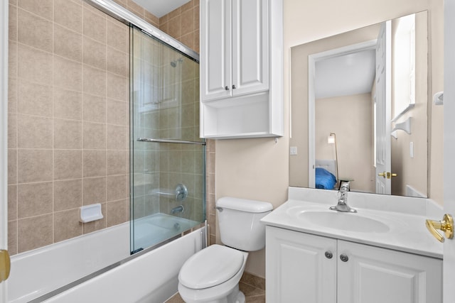 full bathroom with vanity, shower / bath combination with glass door, and toilet