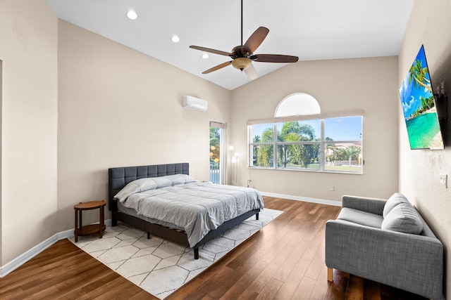 bedroom featuring ceiling fan, light wood-type flooring, a wall unit AC, and lofted ceiling