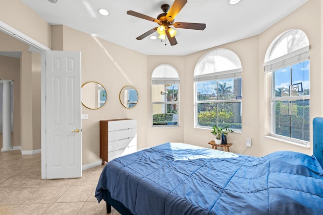 bedroom with ceiling fan and light tile patterned floors