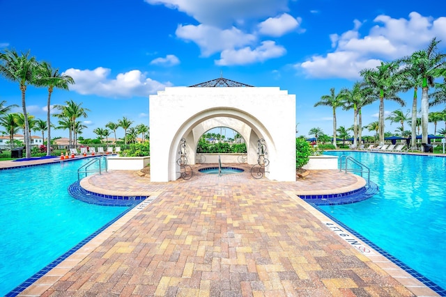 view of pool featuring a patio area and a hot tub