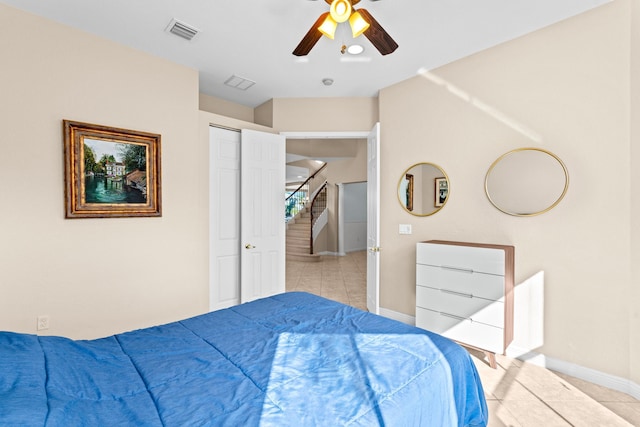 tiled bedroom featuring ceiling fan