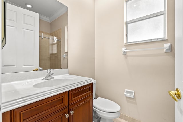 bathroom with ornamental molding, vanity, an enclosed shower, and toilet