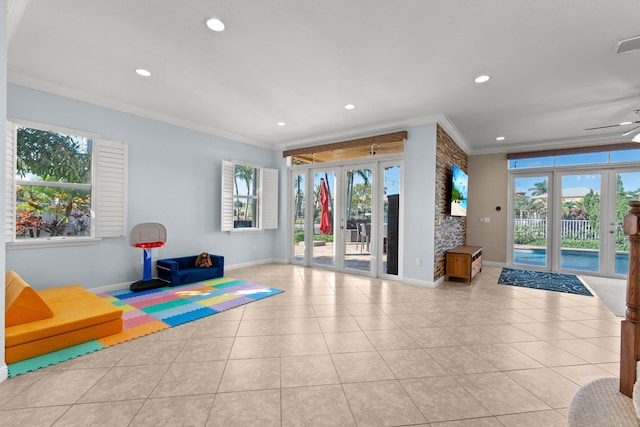 exercise room featuring french doors, light tile patterned floors, and ornamental molding