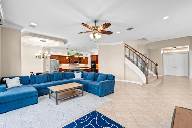 living room featuring ceiling fan with notable chandelier, light tile patterned floors, and ornamental molding