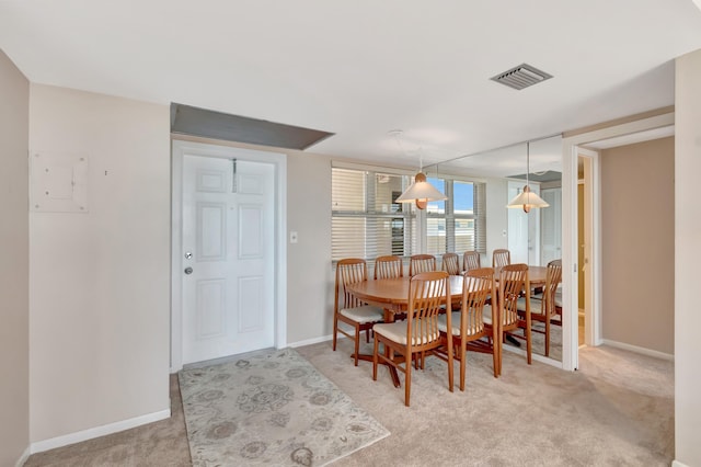 dining room featuring light carpet