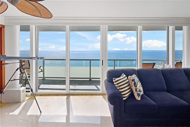 sunroom / solarium featuring a water view